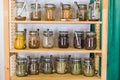 Shelves with a selection of spices and grains in glass jars in zero waste shop