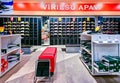 Shelves of sneakers from famous sports manufacturers with discounts on sale in the shopping mall