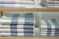 Shelves with towels stacks in shop. Hygge or another scandinavian style