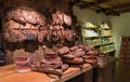 Shelves with typical Italian sausages prosciutto, speck inside a grocery market