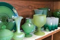 Shelves of used green glassware dishes in thrift shop