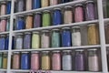 Shelving with glass jars of colorful pigments Royalty Free Stock Photo