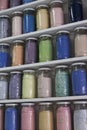 Shelving with glass jars of colorful pigments Royalty Free Stock Photo