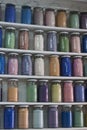 Shelving with glass jars of colorful pigments Royalty Free Stock Photo