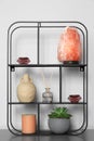 Shelving unit with decorative elements on chest of drawers. Interior design