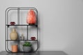 Shelving unit with decorative elements on chest of drawers, space for text. Interior design