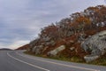 Rocky Facade Along a Mountain Road at the Edge of a Forest Revealing Colorful Fall Foliage Royalty Free Stock Photo