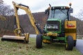 A green John Deere model 6430 tractor with A side hydraulic arm attachment Bengal XR Royalty Free Stock Photo