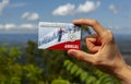 A woman is holding an `America the beautiful` annual pass card