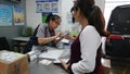 Shenzhen, China: an interior view of the sf express business office as workers pack items for shipment