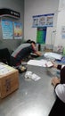 Shenzhen, China: an interior view of the sf express business office as workers pack items for shipment