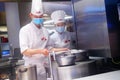 Shenzhen, China: male and female chefs cook in the kitchen