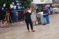 Shenzhen, China: a man with a mental illness picks up food from a dustbin