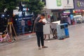 Shenzhen, China: a man with a mental illness picks up food from a dustbin