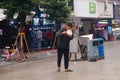 Shenzhen, China: a man with a mental illness picks up food from a dustbin