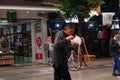 Shenzhen, China: a man with a mental illness picks up food from a dustbin