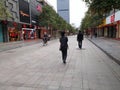 Shenzhen, China: prevent and combat new coronavirus pneumonia, street view, a small number of pedestrians, all wearing masks, and Royalty Free Stock Photo