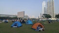 Shenzhen, China: it`s sunny and warm. Citizens relax on the park lawn, some set up tents, and the family is enjoying their leisure