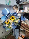 Shenzhen, China: The staff of an online fresh flower shop is binding flowers according to the order