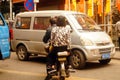 Shenzhen, China: street electric vehicles carrying women