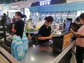 Shenzhen, China: Supermarket cashier is checking customers, this customer gives banknotes; there are few customers who give paper Royalty Free Stock Photo