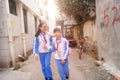 Shenzhen, China: two primary school girls go home on their way home from school