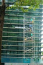 Shenzhen, China: workers clean glass curtain wall in high-rise building Royalty Free Stock Photo