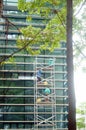 Shenzhen, China: workers clean glass curtain wall in high-rise building Royalty Free Stock Photo