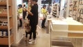 Shenzhen, China: A young man and woman shopping at a supermarket with a pet dog on a leash was uncivilized