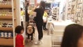 Shenzhen, China: A young man and woman shopping at a supermarket with a pet dog on a leash was uncivilized