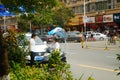 Shenzhen, China: a young woman riding an electric car chats with a man on the road