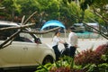 Shenzhen, China: a young woman riding an electric car chats with a man on the road