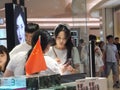 Shenzhen, China: young woman shopping for contact lenses