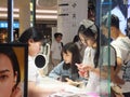 Shenzhen, China: young woman shopping for contact lenses