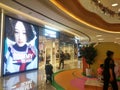 Shenzhen, China: Young women with their children play in a children`s play area in a large shopping mall