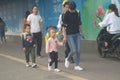 Shenzhen, China: morning street scene, many parents send their children to kindergarten; And working men and women