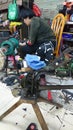 Shenzhen, China: women mend leather shoes. It costs 60 yuan to change the soles of leather shoes.