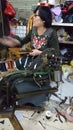 Shenzhen, China: women mend leather shoes. It costs 60 yuan to change the soles of leather shoes.