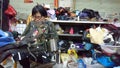 Shenzhen, China: women mend leather shoes. It costs 60 yuan to change the soles of leather shoes.