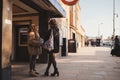 Two black ladies in fur coats standing in front of the underground station Royalty Free Stock Photo