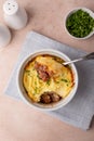 Shepherd\'s pie in a portioned white baking dish. Homemade traditional casserole with minced meat and mashed potatoes.