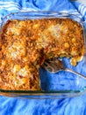 Shepherd's pie, traditional British dish with minced meat and mashed potatoes in glass tray with blue background Royalty Free Stock Photo