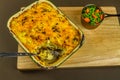 Shepherds or cottage pie in serving dish, one portion taken, with spoon Royalty Free Stock Photo