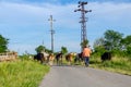 Shepherds are drive a herd of bloodstock cows, walking on the road Royalty Free Stock Photo