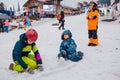 Sheregesh, Kemerovo region, Russia - 05 Apil 2019 : Kids playing with melting snow, making shapes of snow