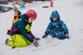 Sheregesh, Kemerovo region, Russia - 05 Apil 2019 : Kids playing with melting snow, making shapes of snow