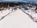 Sheregesh, Kemerovo region, Russia - April 13, 2019: Grelka Fest ski and snowboard riders in bikini. Aerial photo