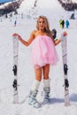 Sheregesh, Kemerovo region, Russia - April 12, 2019: Young happy pretty woman in pink on snow slope with mountain ski