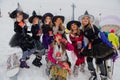 Sheregesh, Kemerovo region, Russia - April 06, 2019: Young women in carnival costumes of witches on the mountain slope