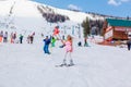 Sheregesh, Kemerovo region, Russia - April 12, 2019: Young happy pretty woman in pink on snow slope riding mountain ski